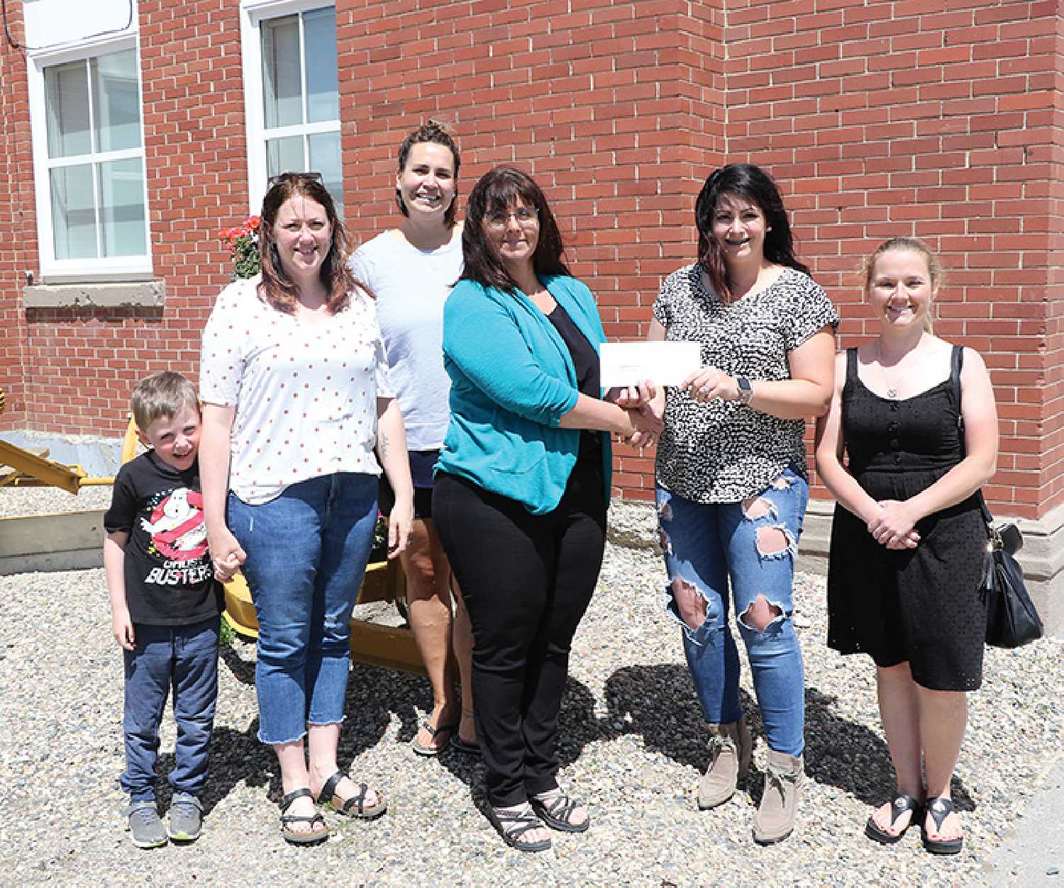 The RM of Moosomin donated $10,000 to the Eastside Playground Committee in support of their project for building a park and playground at 310 Henry Street in Moosomin.  Left are, Chelsea Doane, her son Preston and Andrea Chambers of the Eastside Playground Committee, (middle) CAO of the RM of Moosomin Kendra Lawrence, Andie Hodgson and Dana Jones of the Eastside Playground Committee.
